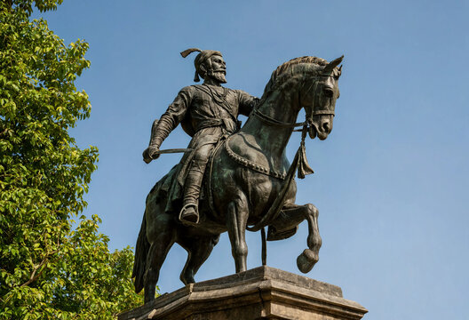 Majestic bronze equestrian statue of the great Indian warrior king Chhatrapati Shivaji Maharaj against a clear blue sky