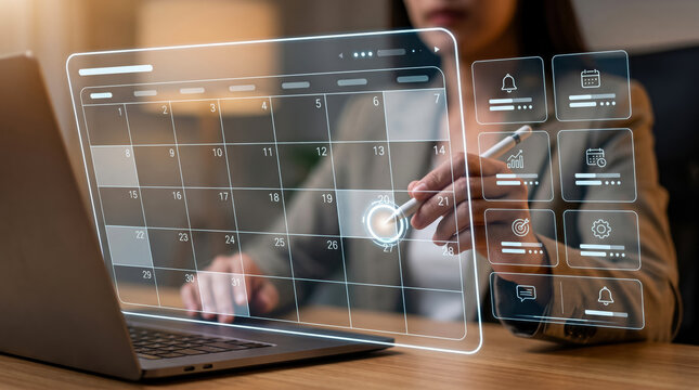 Professional using holographic calendar app on laptop for modern scheduling and productivity management