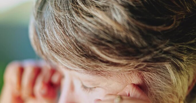 Sad, elderly and woman with tears in home for past moment, memory loss or grief for loneliness. Emotional, widow or senior female person wiping eye for reflection, nostalgia or mourning in house