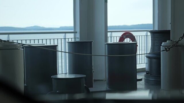 Heavy marine mooring bollards and safety lifebuoy on ferry deck