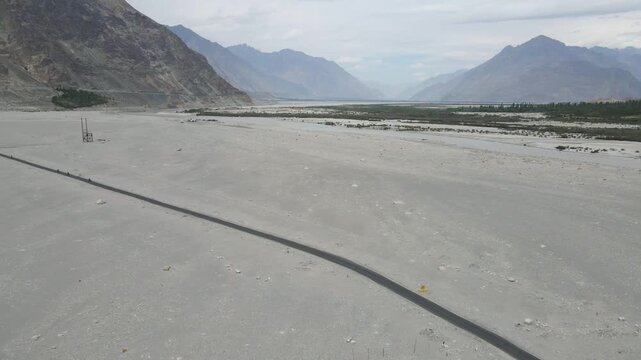 Scenic mountain road near Diskit in Nubra Valley Ladakh India Empty highway through the cold desert landscape of Diskit Ladakh