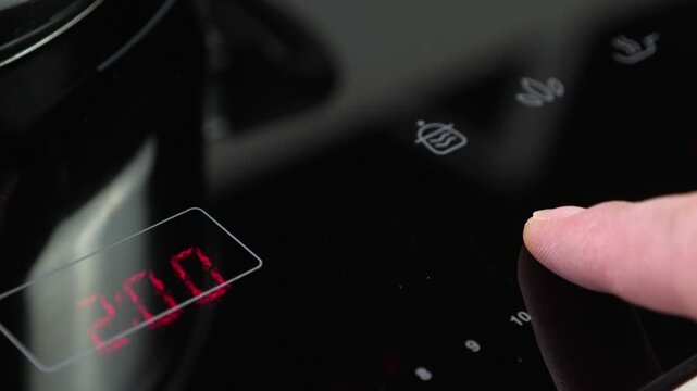 Adjust function on Induction stove and set power, closeup
