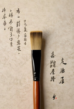 Chinese calligraphy brush on traditional paper with handwritten characters