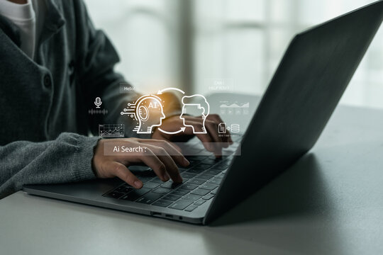 Person using laptop computer with artificial intelligence digital interface showing AI search technology and virtual machine learning concept illustration