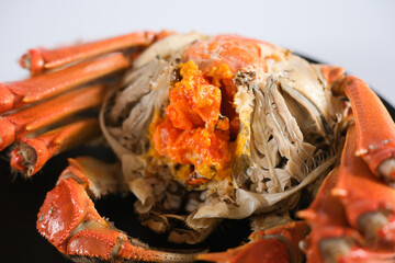 Close up of cooked crab with orange roe © Wang Dan