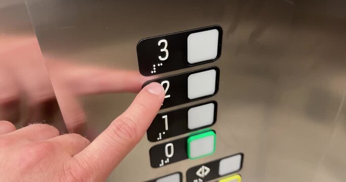 Close-up of a person pressing elevator buttons with Braille markings. Accessibility concept of inclusive design, barrier-free access, public transportation, and building navigation.