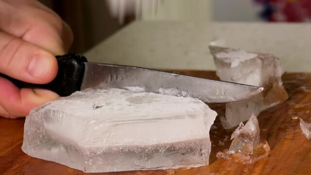 Breaking Ice Block With Meat Tenderizer And Knife