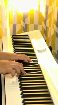 Hands Playing Digital Piano Keyboard In Close Up