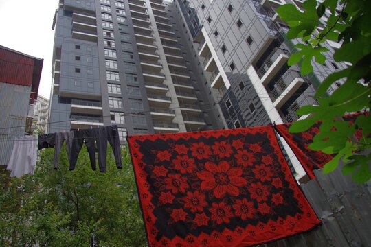 Urban contrast in Batumi with laundry drying against modern skyscraper