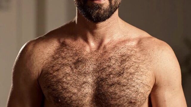Muscular man with hairy chest breathing heavily after workout