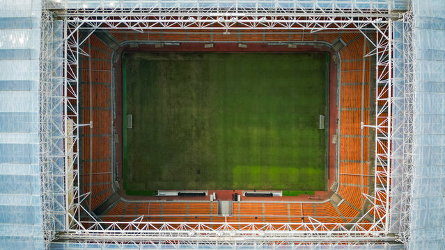 Aerial Top Down View of Football Stadium Pitch and Orange Seating