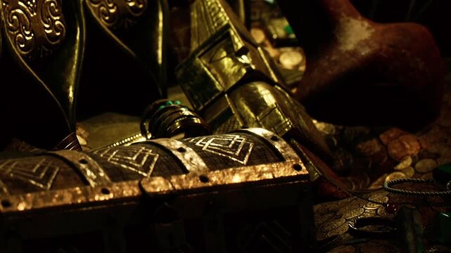 A treasure chest is on a wooden table. Various metal objects and decorations surround the chest. The setting looks dim, suggesting mystery and discovery.