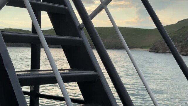 A ship's ladder overlooks the calm waters of Lake Baikal in Olkhonsky District, Irkutsk Oblast, Russia