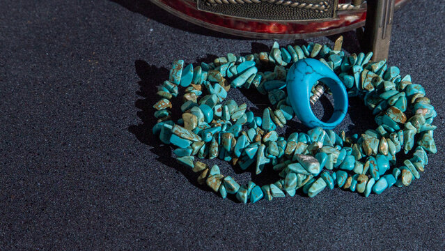 Turquoise beads bracelet ring. Jewelry blue color natural materials. Black background.