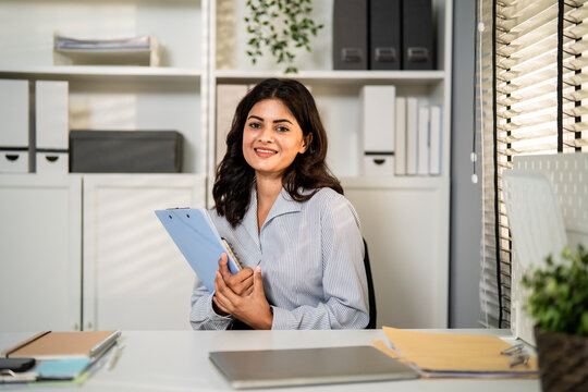 Portrait of young Indian businesswoman working in the modern office. 