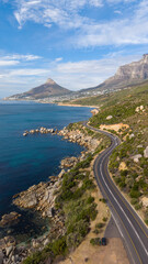 Scenic winding coastal road south of Camps Bay, South Africa, beneath a clear blue sky. Lion's Head and Camps Bay form a spectacular backdrop to one of Cape Town's most iconic coastal drives. © Remo Peer