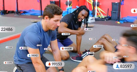 Trainers anchoring feet and cueing as clients doing fast crunches in gym, overlays tracking reps © vectorfusionart