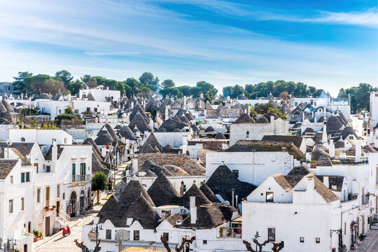 beautiful extraordinaty mediterranean town of Alberobello in Italy with old vintage houses trulli with white walls and tile conical roofs. Traditional european architecture. UNESCO heritage.
