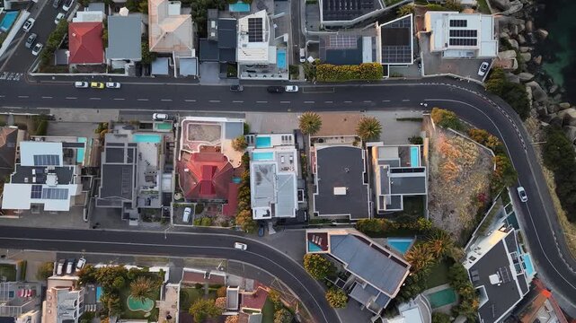 Camps Bay, South Africa - January 26, 2026: Aerial view of luxury houses and villas during the evening, captured by drone. Warm lights, modern architecture and quiet residential streets.