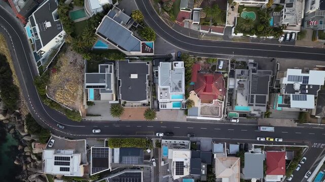Camps Bay, South Africa - January 26, 2026: Aerial view of luxury houses and villas during the evening, captured by drone. Warm lights, modern architecture and quiet residential streets.