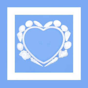 White seashell heart shape wreath on blue background with border frame. Romantic natural sea life symbol of love for Valentines, anniversary or birthday greeting card.