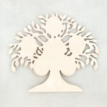 Wooden tree shape natural wood sculpture design on mottled gray background. Decorative abstract concept for save the trees, green and environmental issues.
