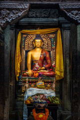Fototapeta premium Buddha statue and an offering at it. Altar, or 