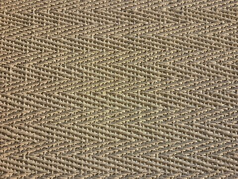Beige zigzag chevron pattern woven textile texture.