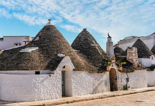 beautiful fancy buildings trulli in Puglia , Italy. Fantastic italian architecture with old houses with white walls and round conic roofs.