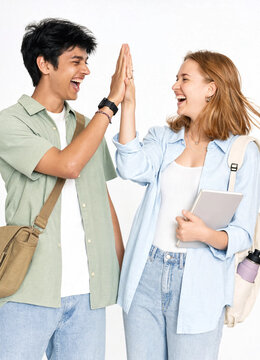Cheerful young male and female students giving high five and laughing on white background