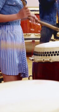 Taiko, performance or hands in class with drums, traditional activity or audio coordination in band practice. Percussion, beat or people with instrument, synchrony rehearsal or music lesson in Japan.