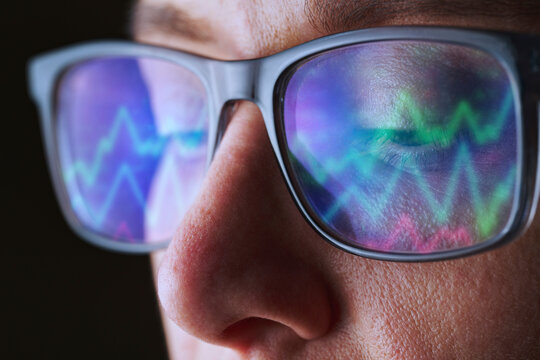 Woman analyzes stock market graph indoors