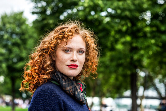 Portrait of redheaded young woman with red lips