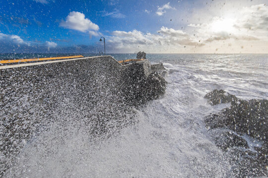 Heavy wave crashing against Cais da Ponta do Sol pier in Madeira