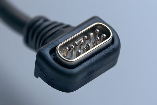 A black serial cable fitted with metal prongs. It connects round plugs to link electronic gadgets for data exchange. This outdated hardware facilitates computer peripheries and equipment for system fu