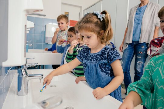 Children brushing their teeth in bathroom of a kindergarten