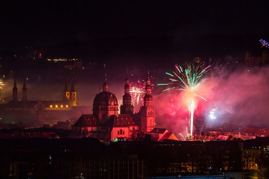 Germany, Bavaria, Wurzburg, New Years Eve fireworks exploding over Haug Monastery