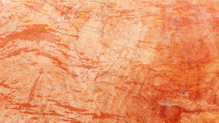 Fototapeta premium Detailed orange stone texture showing natural cracks and rough surface