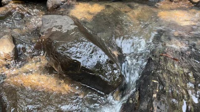 Clear mountain stream flowing over natural rocks 38