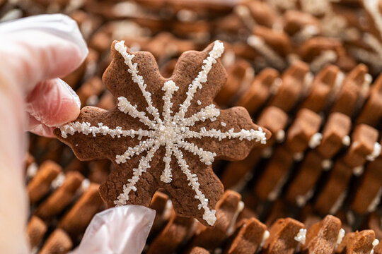 Snowflake Gingerbread Cookie Among Rows of Festive Holiday Treats
