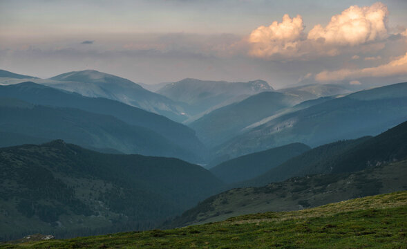 view on hills and carpathian mountains at the evening under cloudy sky summit in Romania