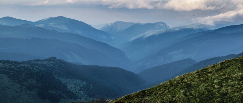 view on hills and carpathian mountains at the evening under cloudy sky summit in Romania