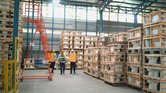 Large industrial warehouse interior with stacked wooden crates and boxes organized for storage and worker inspecting products with safety gear inside bright facility