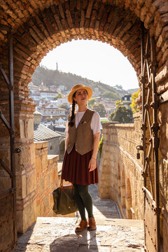 October 2024 Tbilisi Georgia woman in historic brick archway editorial