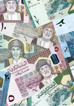 Omani rial money bills pile on table. Oman banknotes of OMR currency close up.