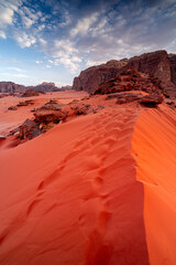 Vertical photo red desert with rocks and dunes at sunset in Wadi Rum, Jordan, nature landscapes Middle East. © Tomasz
