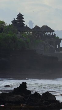 Rugged Coast With Sacred View. Oceanfront Adventure Highlighting Wild Shorelines And Temple Scenery. Excursion Along Untamed Coastlines Featuring Tanah Lot Temple And Splashing Ocean Waves,Bali