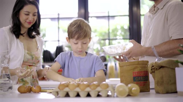 Caucasian family parent and son kneading dough for pizza or cookies