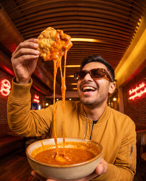 Expressive eating portrait with delicious Asian noodles