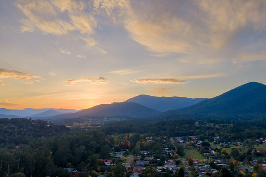 Aerial view of pre dawn colour over mountains above a regional township